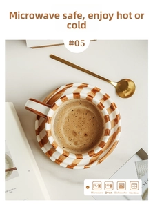 Top view of hand-painted striped ceramic coffee cup with saucer on marble table