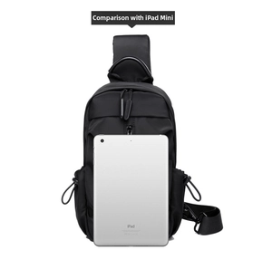 Detailed comparison of the black tactical chest bag size against an iPad Mini tablet