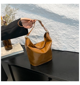 Close-up of caramel vintage hobo bag with matte faux leather and soft slouchy silhouette