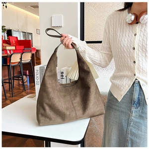 Detail of large khaki tote bag made of frosted suede material in a cozy setting