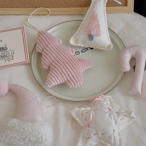 Pink and white fabric Christmas tree ornaments in star, candy cane, and hat shapes