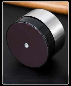 Macro detail of kitchen timer with magnetic base and brushed metal finish on wood background