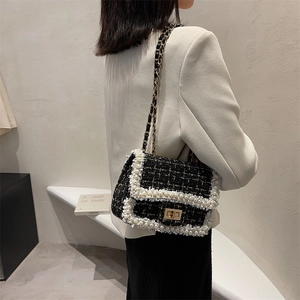 Chic black tweed crossbody bag with white pearl trim and gold chain shoulder strap