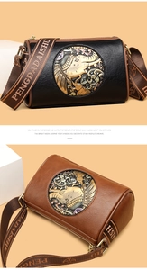 Detailed relief of an elephant on retro shoulder bag with embossed metal disc and wide strap