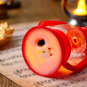 Detail view of red LED lantern base with power switch and secure battery compartment