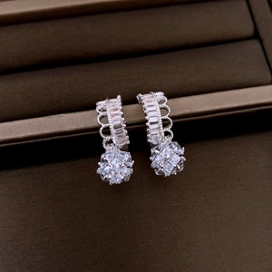 Macro shot of silver drop earrings with star zircon and pearls in a jewelry box