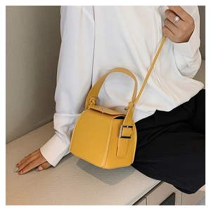 Yellow PU leather box bag shown styled with a white shirt and black trousers