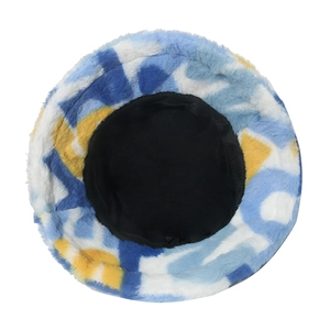 Colorful faux rabbit fur bucket hat with blue and yellow abstract pattern for winter