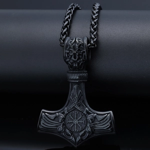 Macro view of matte black Viking Mjölnir pendant with intricate Nordic relief details