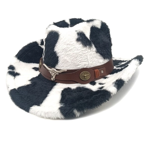 Detail of cow print cowboy hat with plush texture, faux leather band and bull head emblem