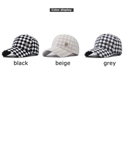 Detailed view of plaid baseball caps in black, beige and grey with metallic M emblem