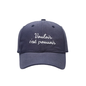 Deep blue cotton baseball cap with white Vouloir c'est pouvoir embroidery