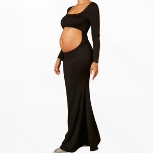 Detail view of black long sleeve maternity dress with hollow waist cut-out and floor length