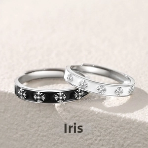 Detail of couple rings featuring black and white enamel iris patterns and open band design