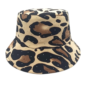 Close-up of leopard print bucket hat with small rhinestone embellishments on canvas