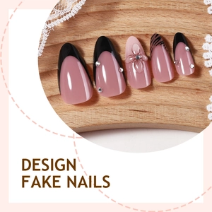 Handmade almond fake nails with black french tips and 3D floral rhinestone accents