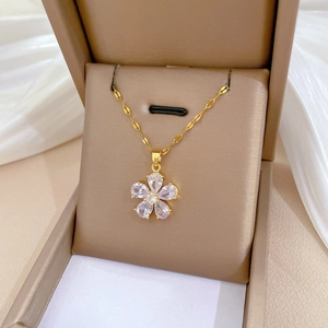 Macro shot of gold-plated flower pendant necklace featuring pear-cut zircon crystals