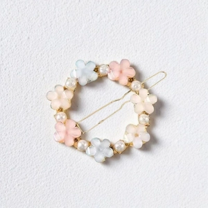 Floral circular hair clip with matte pastel flowers and pearls on golden wire frame