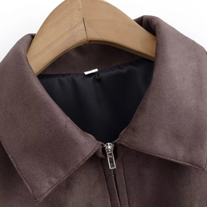 Close-up of brown suede jacket featuring a classic lapel and premium silver metal zipper