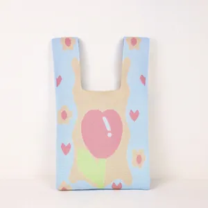 Detailed knit texture and floral tulip pattern on blue woven handheld bucket bag