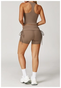 Rear view of brown high-waist yoga set featuring a racerback top and side drawstring shorts