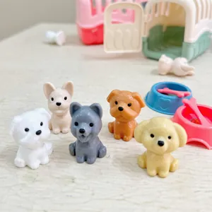 Close-up of five mini resin dog figurines including French Bulldog and Pomeranian