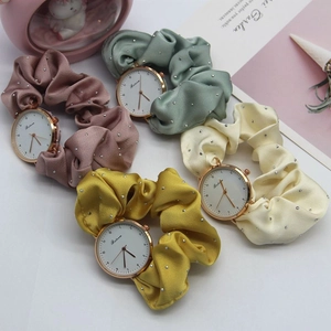 Elegant ribbon scrunchie watches in pink, green, yellow, and beige with gold metal cases