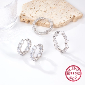 Detail of 925 sterling silver hoop earrings with irregular pavé cubic zirconia