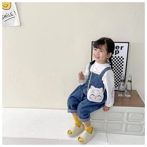 Close-up of cute white cat-shaped PU leather crossbody bag for little girls on a model