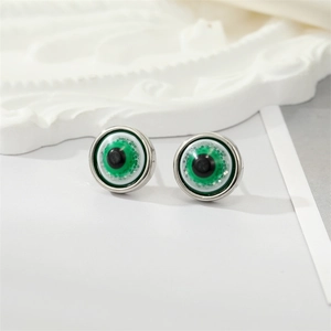 Macro shot of green evil eye stud earrings with detailed pupil and silver metal edge