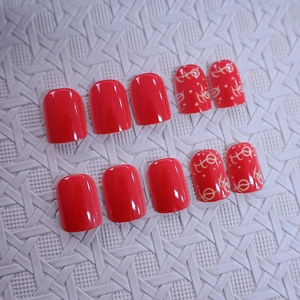 Classic Christmas red press-on nails set with glossy finish and white geometric patterns