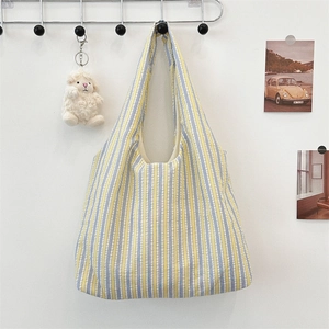 Detail of colorful vertical striped canvas tote bag texture with wide shoulder strap