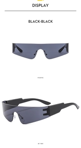 Close-up of black frameless Y2K sunglasses with wide arms and curved futuristic lenses