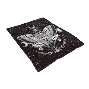 Macro shot of celestial moth flannel blanket with moon phases and zodiac patterns