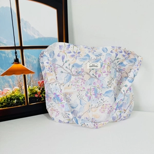 Floral canvas shoulder bag with purple and pink flower patterns on a white background