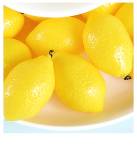Macro view showing realistic texture of artificial yellow lemons in a white bowl