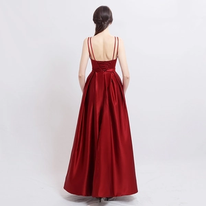 Elegant burgundy satin evening gown featuring a cross-strap backless design and a long train