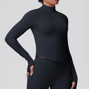 Detail of black rib-knit yoga jacket with stand collar, metal zipper, and thumbholes