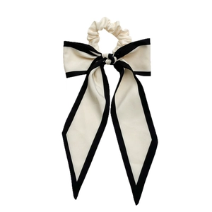 Large black and white bow scrunchie with long ribbons for elegant ponytail styling