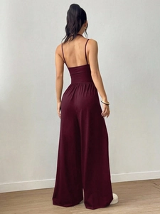Detail of burgundy backless wide-leg jumpsuit showing the elegant open back and silhouette