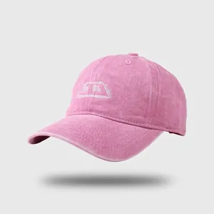 Close-up of pink washed cotton baseball cap featuring white embroidered geometric logo