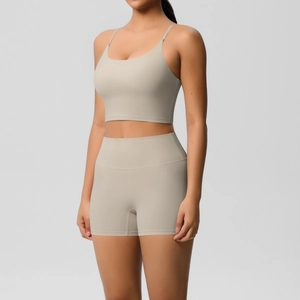 Detail of high-stretch seamless sand beige yoga set showing slim straps and high waist shorts
