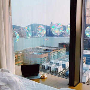 Rainbow prism window film showing holographic circular design with a scenic city view