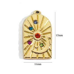 Detailed view of arch pendant with sun, crescent moon and colorful inset gemstones