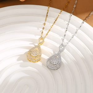 Detail of water drop pendant necklaces in gold and silver finish with pavé set zircons
