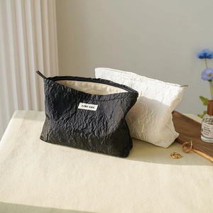 Black and white floral rose jacquard makeup bags with large capacity on a tray