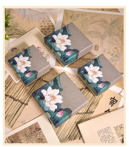 Detail of square paper jewelry boxes with elegant lotus print and retro Chinese style
