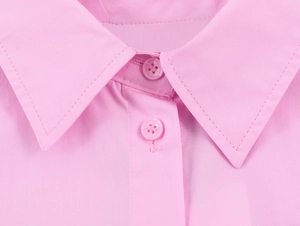 Detailed close-up of pink poplin shirt collar with matching resin buttons and stitching