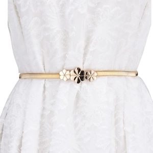 Elegant gold metal leaf elastic waist belt with floral buckle on a white lace dress
