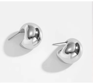 Close-up of polished silver crescent hoop earrings in high-shine 18K titanium steel
